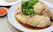 Delicious Singaporean Hainanese chicken rice with tender poached chicken, herbs, and flavorful sauce.
